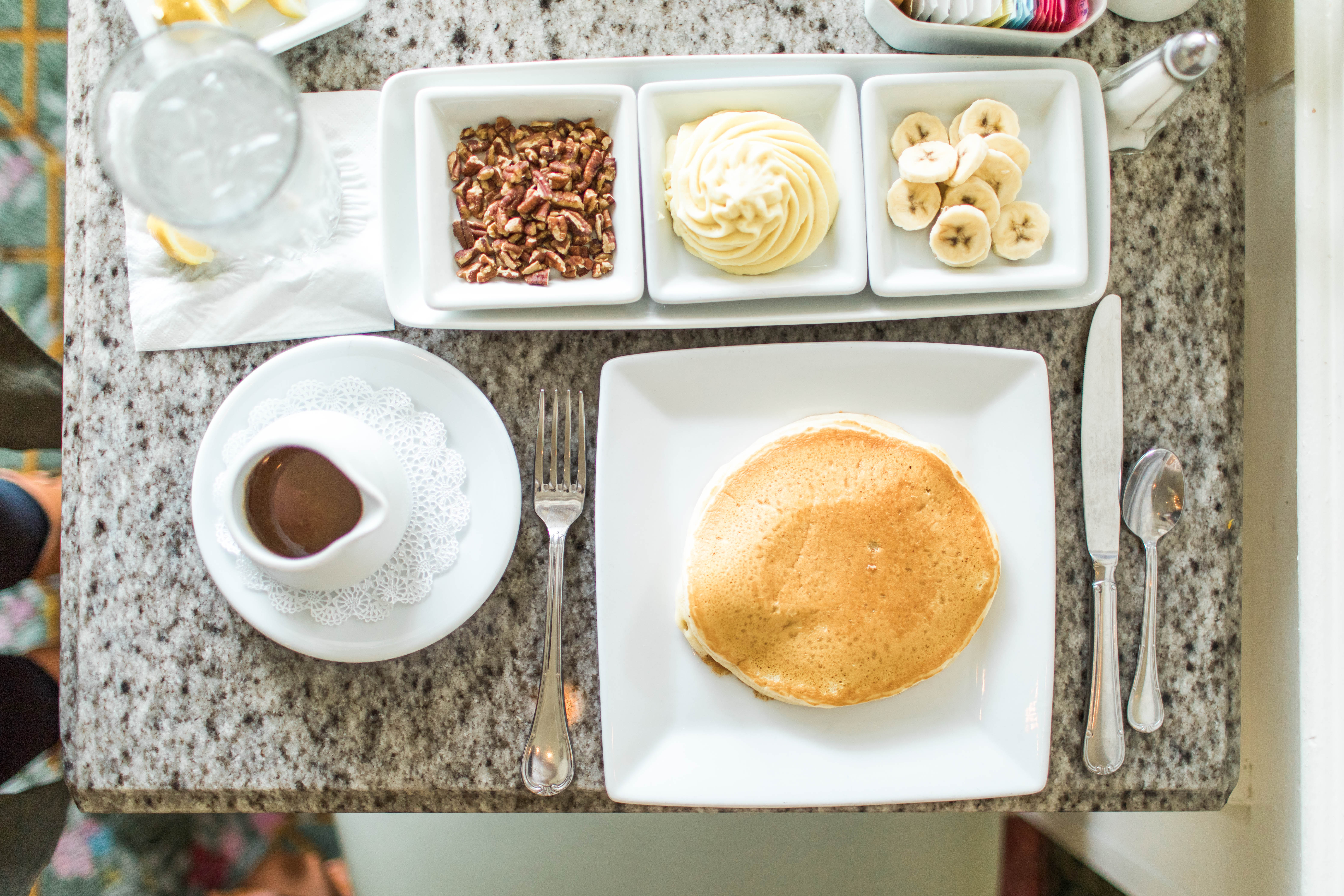 Pancakes with caramel, pecan, whip cream and banana topping